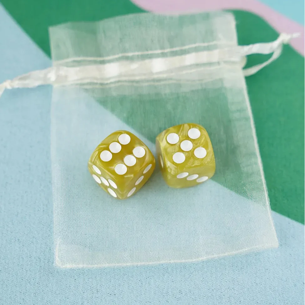 A pair of olive green 5/8 inch marbled acrylic mahjong dice with white pips in a sheer organza pouch.